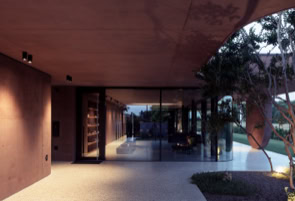 Shaded portico with vegetated light wells, a key feature connecting architecture and nature.