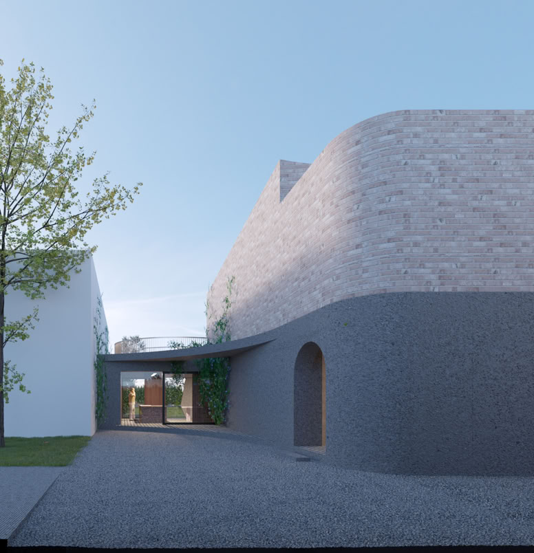 Frontal view of the building with irregular geometry in dialogue with the surrounding vegetation.