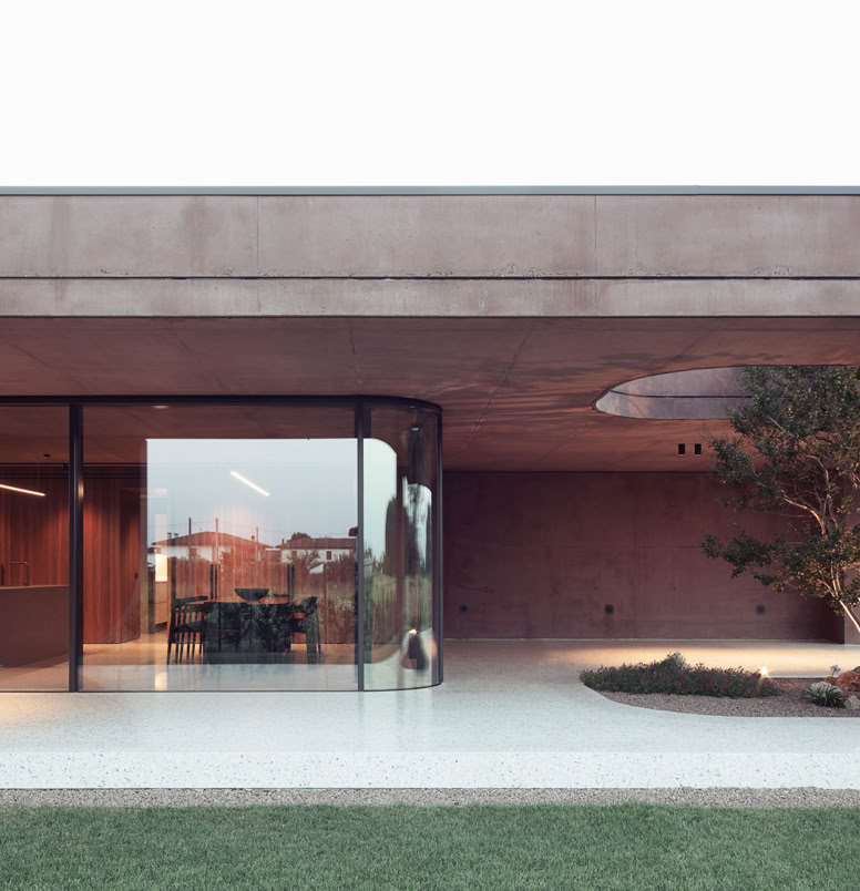 Minimalist single-level villa by MIDE architetti with panoramic glass, open-plan living spaces, and harmonious integration with the surrounding garden. 