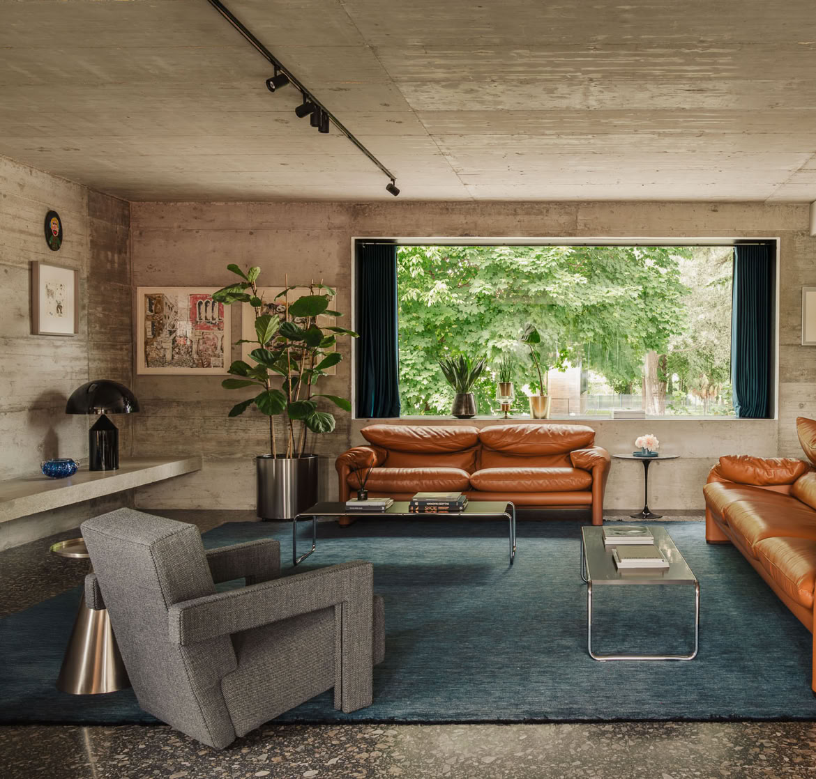 Living room area with raw concrete and terrazzo. A contemporary private residence in Vigonza designed by MIDE architetti.