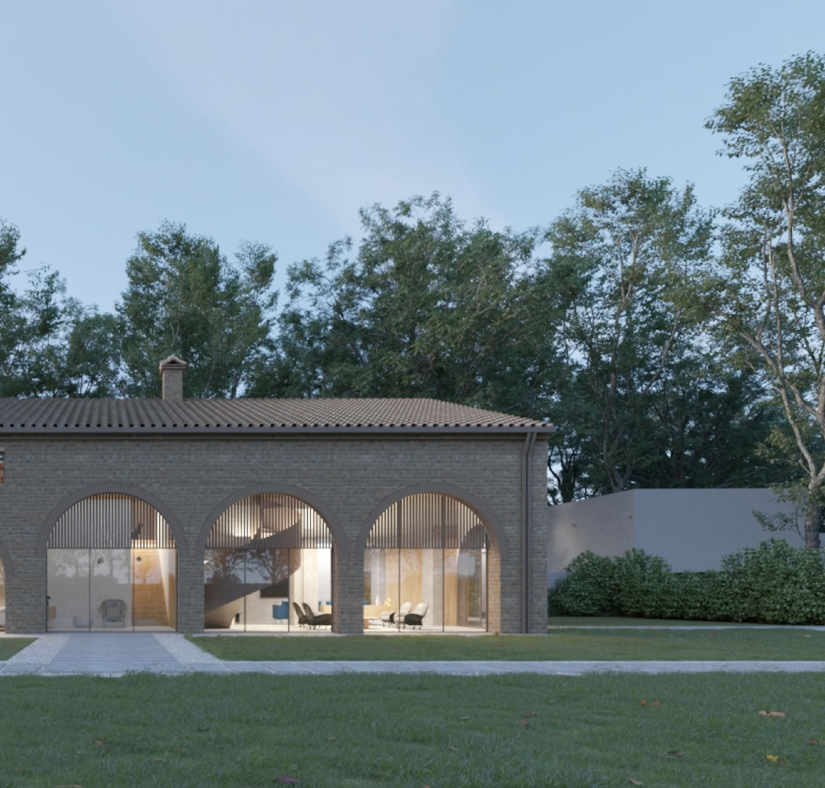Exposed brick façade of the restored Napoleonic-era farmhouse by MIDE Architetti, combining historic charm and luxury contemporary design.