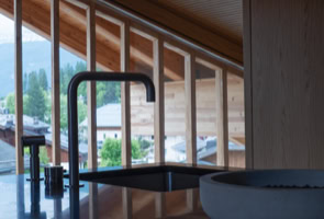 Modern and refined kitchen with panoramic Dolomites views in Cortina d’Ampezzo.