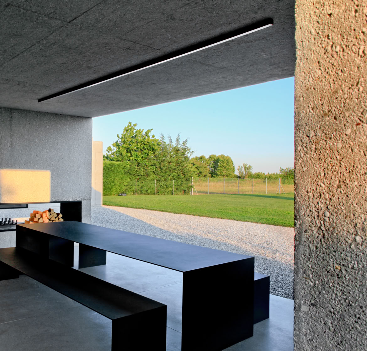 Private garden with a rainwater recovery system and integrated vegetation as part of the architectural composition.