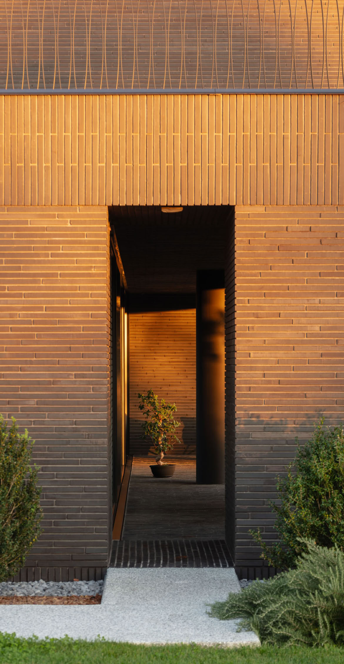 Detail of the entrance to the brick villa set within the park, designed by MIDE architetti.