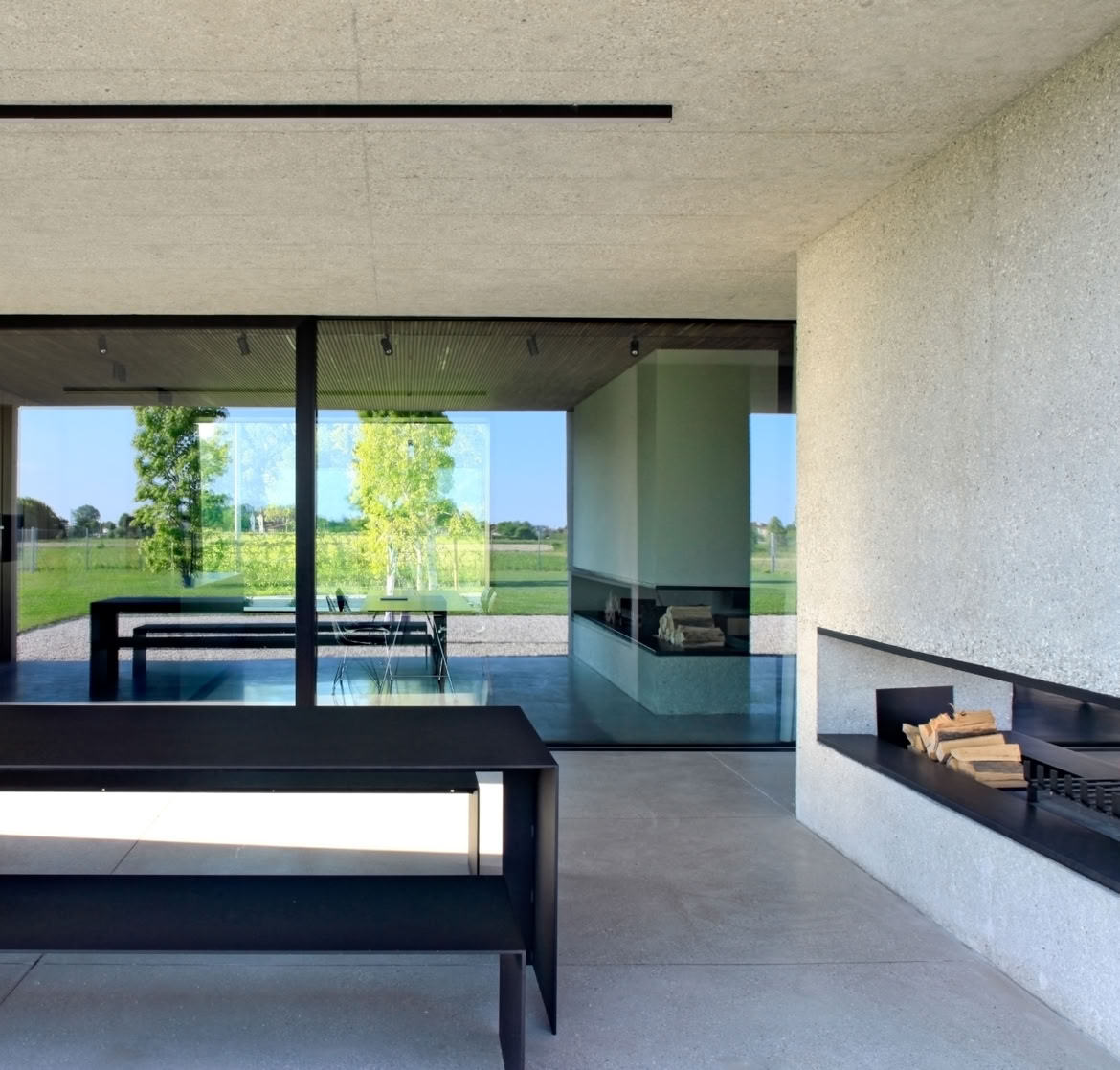 Private garden with a rainwater recovery system and integrated vegetation as part of the architectural composition.